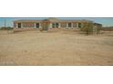Exterior view of the home, showing its facade and the surrounding natural landscape at 13217 S Tuthill Rd, Buckeye, AZ 85326
