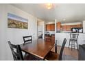 Casual dining area adjacent to the kitchen, featuring a wooden table and wall art at 1350 S Greenfield Rd # 2133, Mesa, AZ 85206