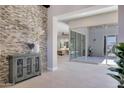 Inviting foyer featuring an accent wall, decorative cabinet, and an open layout leading to living spaces at 17183 W San Marcos St, Surprise, AZ 85388