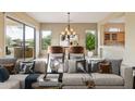 Relaxing living room area with an open space to dining room and sliding door access to the outdoor patio at 19803 N Desert Song Ct, Surprise, AZ 85374