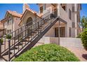 Exterior view of residential condo with private entrance, outdoor stairway, and desert landscaping at 19820 N 13Th Ave # 175, Phoenix, AZ 85027