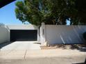 A two car garage behind a privacy wall offers security and seclusion for your vehicles and home at 2068 E Cairo Dr, Tempe, AZ 85282