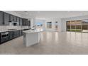 Gorgeous kitchen with a large island, dark cabinets, and stainless steel appliances at 21541 W Mariposa St, Buckeye, AZ 85396