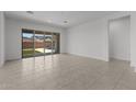 Bright living room with tile flooring, large sliding glass doors, and backyard views at 21541 W Mariposa St, Buckeye, AZ 85396