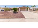Charming single-story home featuring desert landscaping and covered carport at 2423 E Dahlia Dr, Phoenix, AZ 85032
