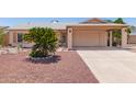 Single story home with desert landscaping and covered carport at 2423 E Dahlia Dr, Phoenix, AZ 85032