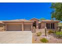 Charming home featuring a tile roof, three-car garage, and professionally landscaped desert-style yard at 25633 N 71St Dr, Peoria, AZ 85383