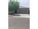 Lovely home featuring a spacious driveway, two-car garage, and desert landscaping at 3211 W Pollack St, Phoenix, AZ 85041