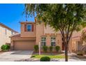 Charming two-story home with a well-maintained lawn, mature trees, and desert landscaping at 4043 E Carla Vista Dr, Gilbert, AZ 85295