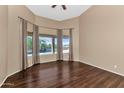 Bright bedroom with hardwood floors and large windows overlooking the backyard pool at 4239 W Reddie Loop, Phoenix, AZ 85083