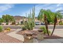 This home features a desert landscape, an attractive facade, and mountain views at 4239 W Reddie Loop, Phoenix, AZ 85083