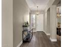 Elegant foyer featuring wood floors, high ceilings, and stylish light fixture at 4338 E Hamblin Dr, Phoenix, AZ 85050
