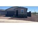 Charming single-story home with a two-car garage and well-maintained landscaping at 5573 S 246Th Ave, Buckeye, AZ 85326