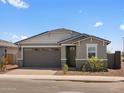 Charming single-story home with a well-maintained front yard and a two car garage at 5573 S 246Th Ave, Buckeye, AZ 85326