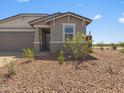 Attractive, low maintenance desert landscaping leads to the home's entryway at 5573 S 246Th Ave, Buckeye, AZ 85326