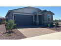 Charming single-story home featuring a brick driveway and a well-maintained, xeriscaped front yard at 5573 S 246Th Ave, Buckeye, AZ 85326