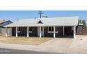 Cozy single-story home with a covered front porch and driveway at 6012 W Flower St, Phoenix, AZ 85033