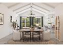 Bright dining area with a large table, comfortable seating, an elegant chandelier, and abundant natural light at 667 E Brown Way, San Tan Valley, AZ 85140
