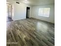 Bright living room features wood-look flooring and a large window at 7126 N 19Th Ave # 224, Phoenix, AZ 85021