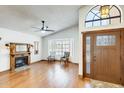 Bright living room boasts hardwood floors, arched windows, fireplace, and a stylish ceiling fan at 7253 S Terrace Rd, Tempe, AZ 85283
