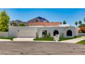 Modern home featuring white stucco, red tile roof and a view of a mountain in the background at 7328 E Laredo Ln, Scottsdale, AZ 85250