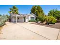 Charming home featuring a covered parking space with a long driveway and desert landscaping at 8310 E Glenrosa Ave, Scottsdale, AZ 85251