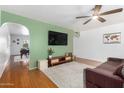 Bright living room features a ceiling fan, archways, and hardwood flooring at 8310 E Glenrosa Ave, Scottsdale, AZ 85251