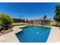 Inviting backyard with a refreshing pool and spacious green area, ideal for outdoor living at 9436 N 41St Dr, Phoenix, AZ 85051