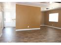 Open living room with laminate flooring, a ceiling fan, and a bright window at 9501 E Broadway Rd # 254, Mesa, AZ 85208