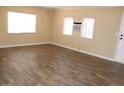 Comfortable living space featuring laminate flooring, great natural light, and an AC unit at 9501 E Broadway Rd # 254, Mesa, AZ 85208