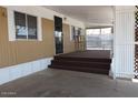 Covered porch with a brown carpeted staircase leading to the front entrance at 9501 E Broadway Rd # 254, Mesa, AZ 85208