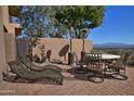 Outdoor patio with lounge chairs, dining table, and shade in a private backyard at 10841 N Mountain Vista Mtn, Fountain Hills, AZ 85268