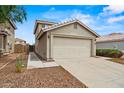 Side view of home featuring a neutral color palette, a two car garage, and desert landscaping at 11710 W Paradise Dr, El Mirage, AZ 85335