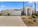 Charming home with a three-car garage, mature landscaping, and desert-style aesthetic at 11993 E Mission Ln, Scottsdale, AZ 85259