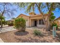 View of the front of the single-story home with neutral stucco and tile roof at 12355 W Hadley St, Avondale, AZ 85323