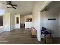 Living room with wood flooring, open entry, and ceiling fan at 12938 W Alvarado Rd, Avondale, AZ 85392