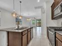 Open kitchen view featuring stainless appliances, a granite island, and subway tile backsplash at 14160 W Georgia Dr, Surprise, AZ 85379