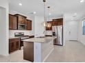 Modern kitchen featuring stainless steel appliances, granite countertops, and pendant lighting at 14160 W Georgia Dr, Surprise, AZ 85379
