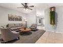 Cozy living room with neutral tones, plush seating, and stylish decor at 14919 W Hearn Cir, Surprise, AZ 85379