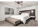 Serene main bedroom with a large window, soft carpet, and contemporary furnishings at 14919 W Hearn Cir, Surprise, AZ 85379