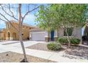 Charming two-story home with a two-car garage, desert landscaping, and an inviting entrance at 15450 W Laurel Ln, Surprise, AZ 85379