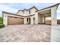 Wide driveway leading to multi-car garage featuring a unique, covered parking area with ample space at 19026 W Becker Ln, Surprise, AZ 85388
