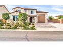Charming home with meticulously landscaped front yard, brick driveway, and covered front porch at 19026 W Becker Ln, Surprise, AZ 85388