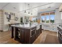 Spacious kitchen with a large island, farmhouse sink, modern appliances, and ample natural light at 19296 N 98Th Pl, Scottsdale, AZ 85255