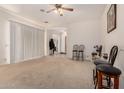 Inviting living room featuring plush carpeting, neutral walls, and a ceiling fan at 1955 E Grand Canyon Dr, Chandler, AZ 85249