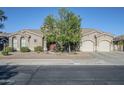 Charming single-story home with a circular turret entrance, three-car garage, and low-maintenance desert landscaping at 22709 S 202Nd St, Queen Creek, AZ 85142
