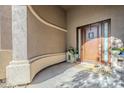 Inviting front entry featuring a wood door with glass accents, sheltered by an arched entryway at 22709 S 202Nd St, Queen Creek, AZ 85142