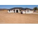 New home with a modern design, featuring a dark roof and bright white accents at 2689 S 305Th Ave Ave, Buckeye, AZ 85326