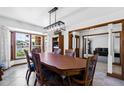 Elegant dining room featuring a large window, stylish chandelier, and classic furniture at 3160 E Fox St, Mesa, AZ 85213
