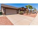 Well-maintained single-Gathering home with a spacious driveway, desert landscaping, and an attached garage at 4110 W Villa Linda Dr, Glendale, AZ 85310